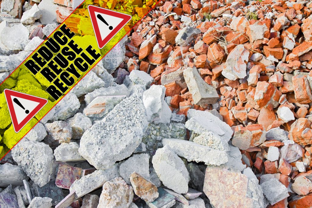 Construction solid waste management in building activity - concept image with text Reduce Reuse Recycle written on a yellow stripe