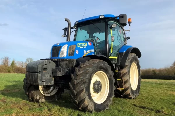 AE Faulks tractor for hire in a field